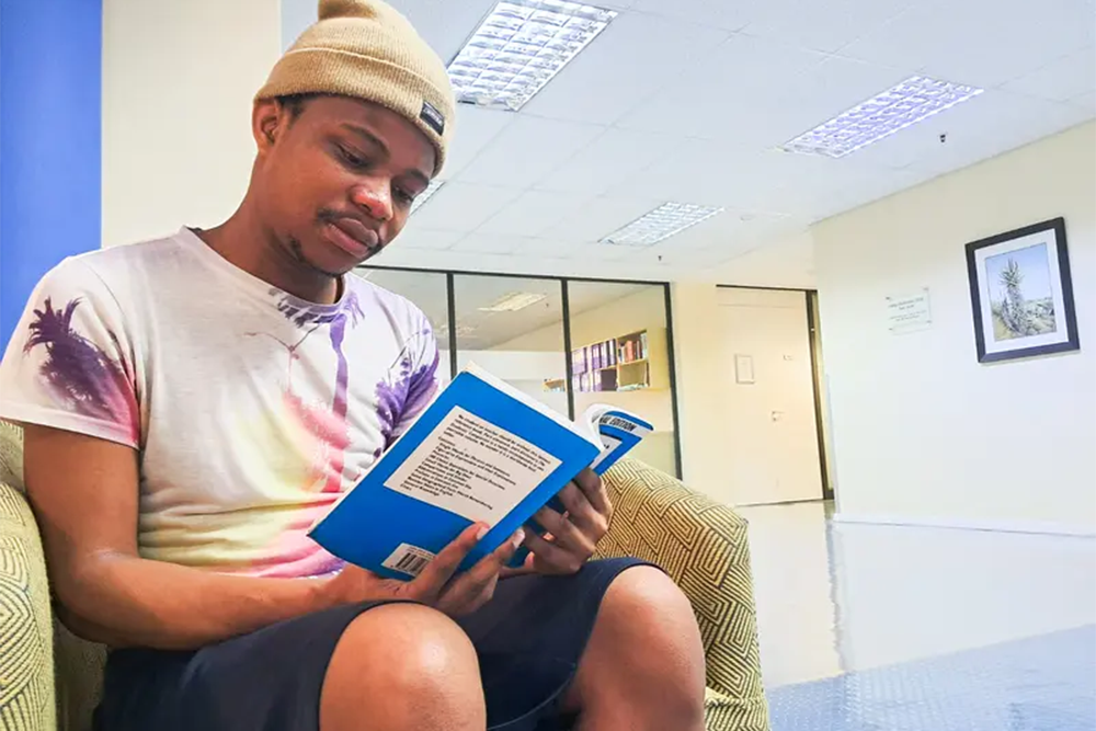 Perseverance: Nhlanhla Malebye overcame the odds on his literacy journey. From reading toilet paper by candlelight as a child to sitting in the Rhodes University library as a young adult. Photo: Christopher Kelly