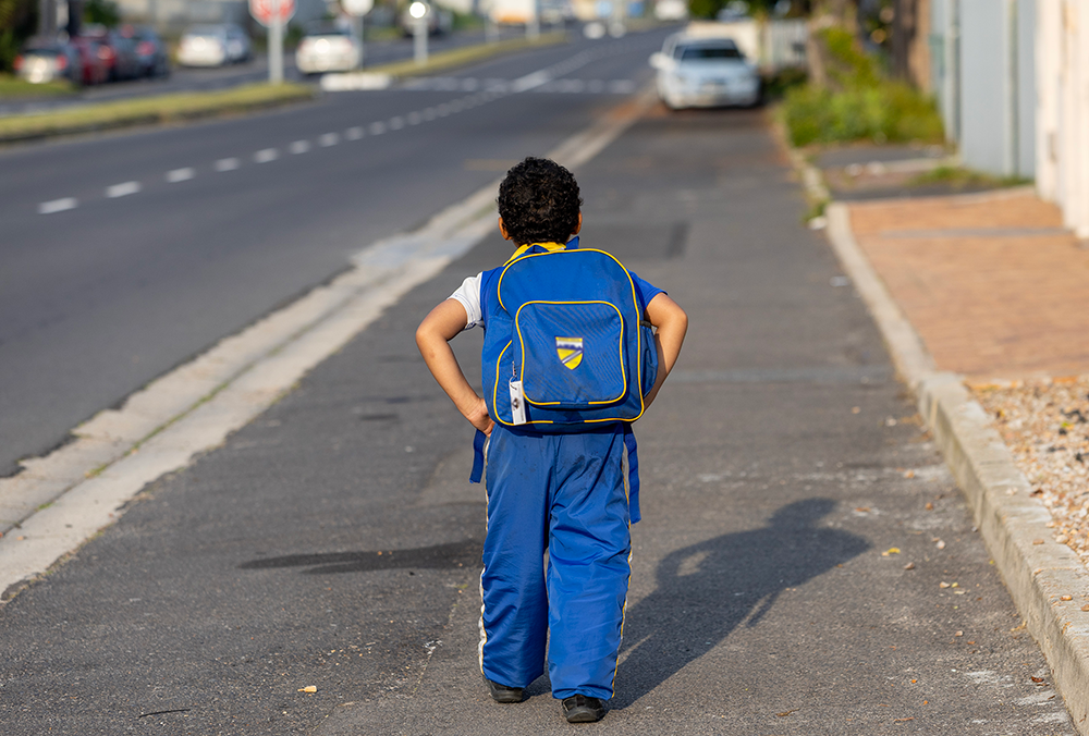 A Grade R pupil walks in Cape Town. The school badge and name tag have been blurred to protect the child's identity. Photo: Shelley Christians/EduDesk
