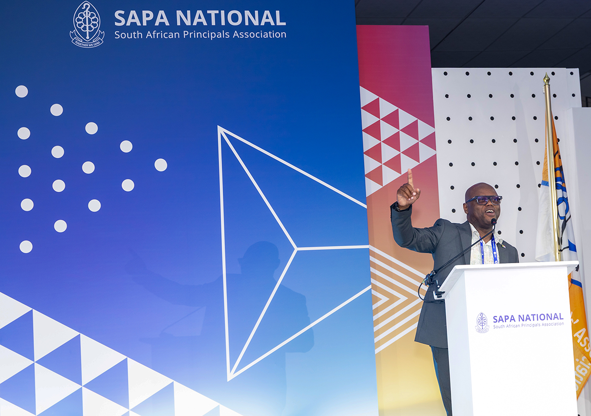 South African Principals’ Association president Mashudu Ramulumo addresses the national conference in Limpopo, raising concerns about delayed school funding, which is forcing some principals to use personal savings and credit to keep their schools running. Photo: Abelife Photography/SAPA